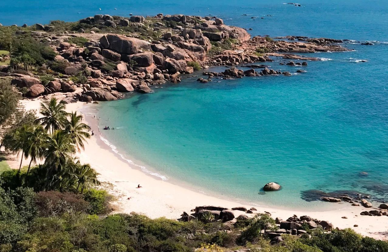 Horseshoe Bay, a palm-lined crescent of sand under a headland of pink granite.