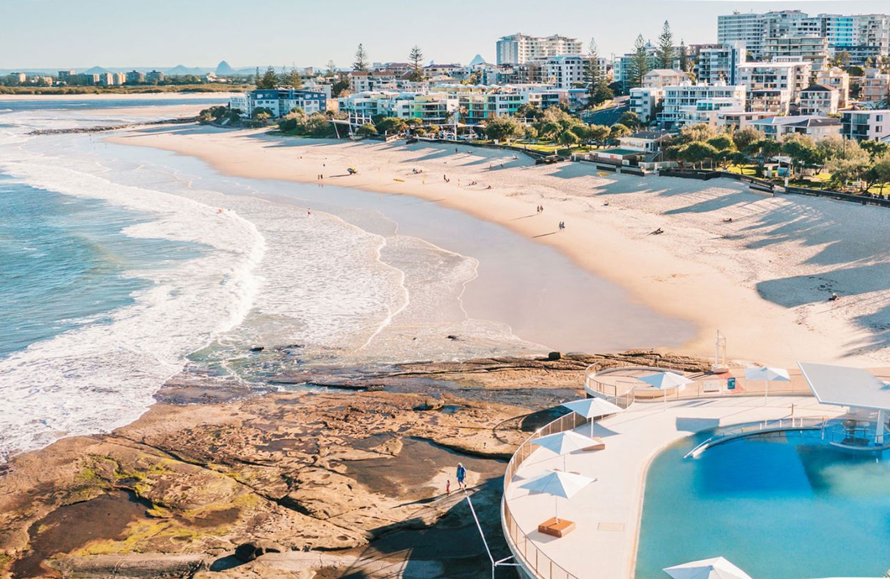 Kings Beach, Caloundra, the ocean pool and rock shelf in warm afternoon light.