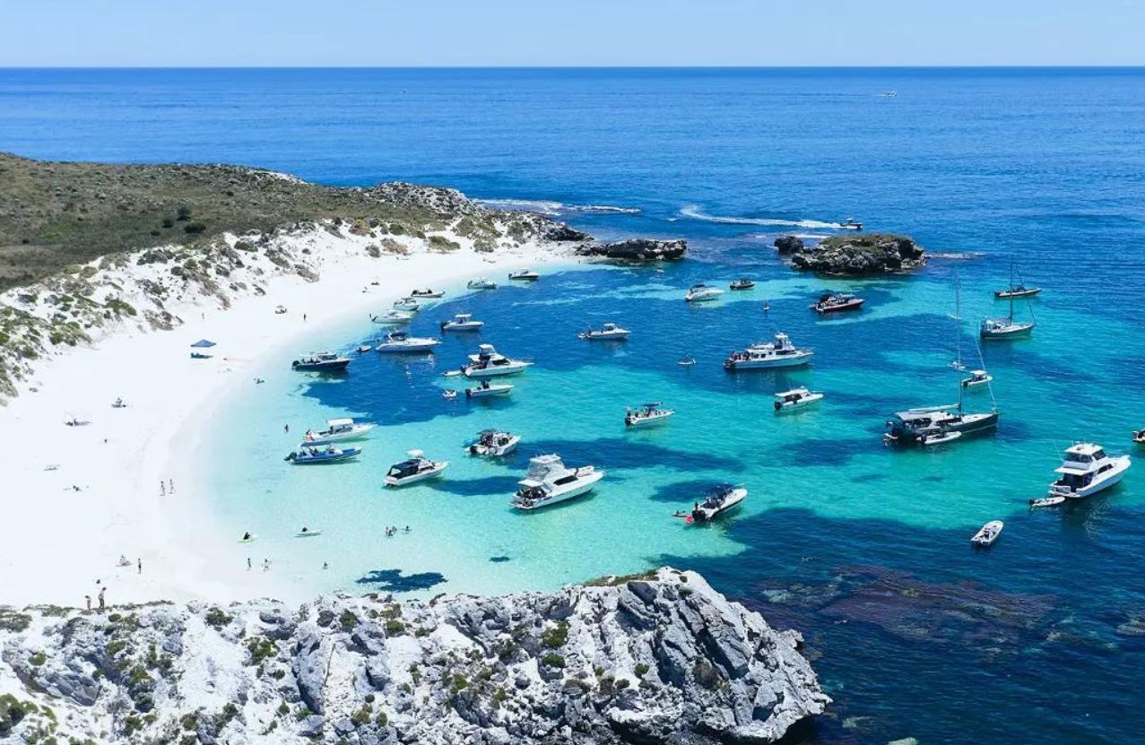 Parakeet Bay on Rottnest, white sand and a bay full of anchored boats.