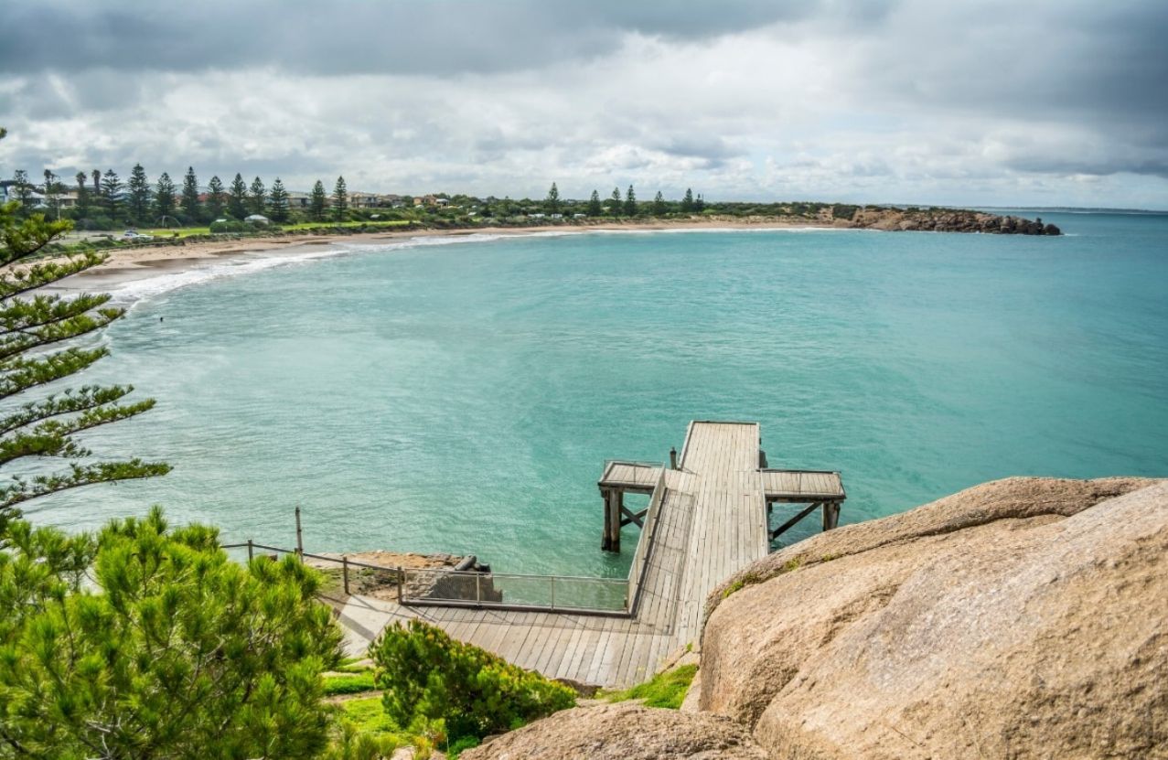 The timber jetty at Horseshoe Bay, Port Elliot, running into a pale green bay.