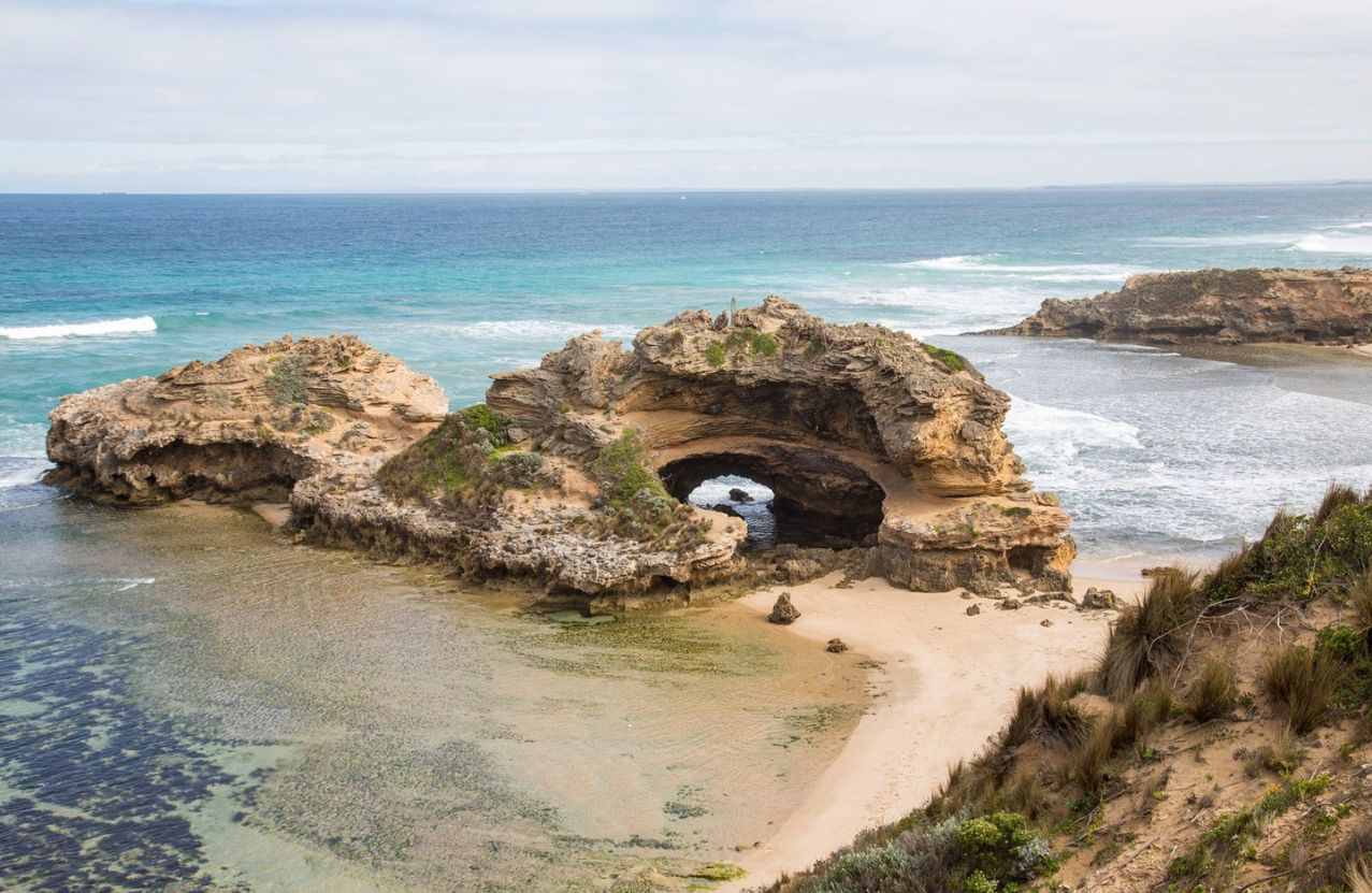 The rock arch at Portsea, a small beach tucked under the limestone and a green rock pool.