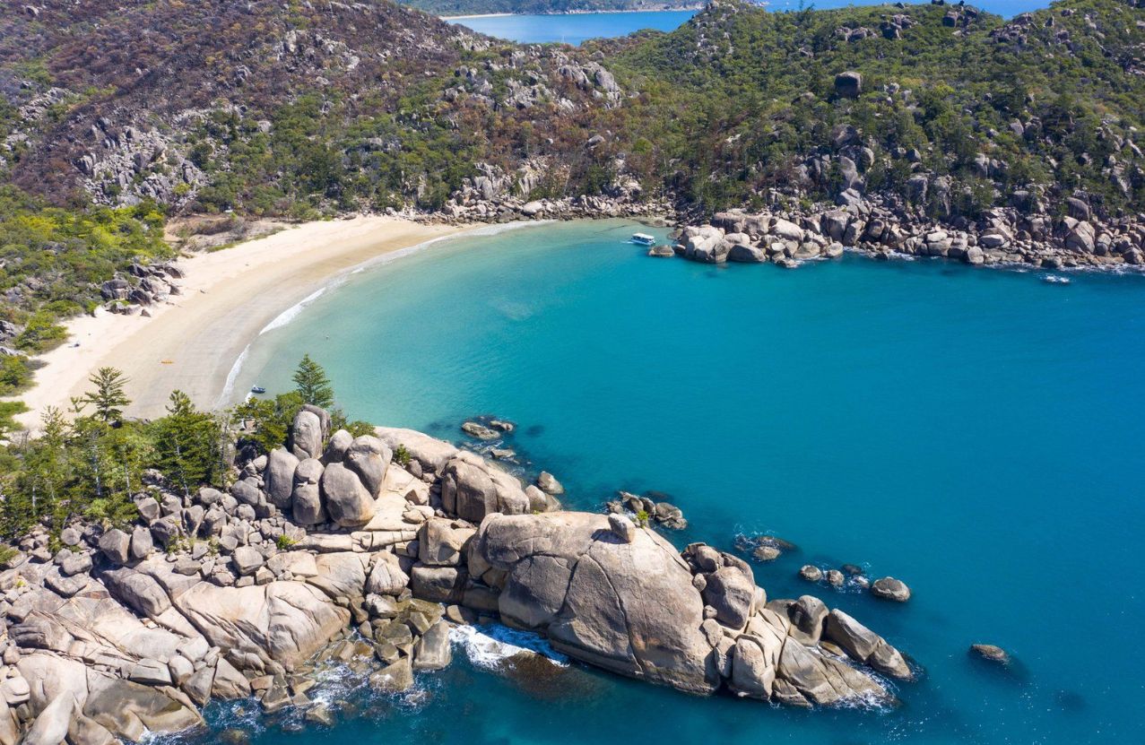 Radical Bay on Magnetic Island, granite boulders around a still turquoise cove.